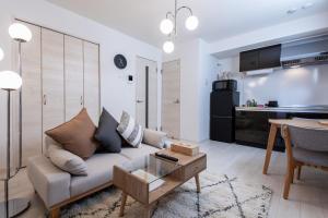 a living room with a couch and a table at New Open! SunLight 岸里 in Osaka