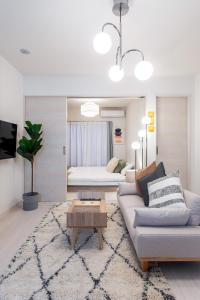 a living room with a couch and a table at New Open! SunLight 岸里 in Osaka
