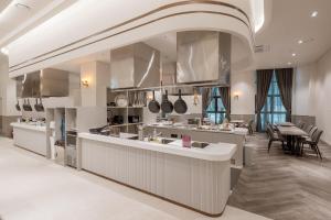 a large kitchen with a counter and a dining room at Chestertons Sokcho in Sokcho