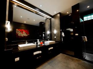 a bathroom with two sinks and a large mirror at The Pavilions Phuket in Bang Tao Beach
