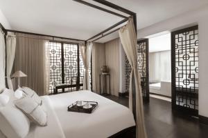 a bedroom with a bed with a tray on it at The Pavilions Phuket in Bang Tao Beach