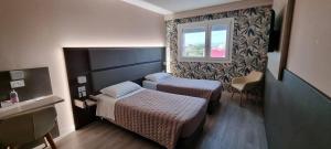 a hotel room with two beds and a window at Art Hotel Udine in Udine