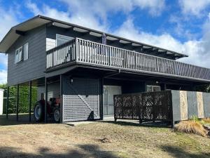 a large house with a balcony and a garage at Lake Views, Ani Miria Place, Te Rangiita, Turangi in Turangi +13 photos