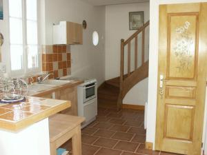a kitchen with a sink and a stove at Les séquoias in Javerdat