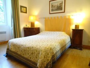 a bedroom with a bed and two night stands and two lamps at Les séquoias in Javerdat