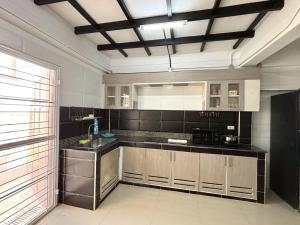 a kitchen with a sink and a counter top at Anchan Home Stay Hatyai in Hat Yai