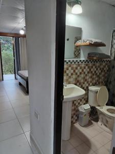 a bathroom with a toilet and a sink at Finca Kapok tree in Miramar