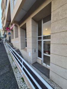 a building with windows on the side of a street at LandS in Caniço