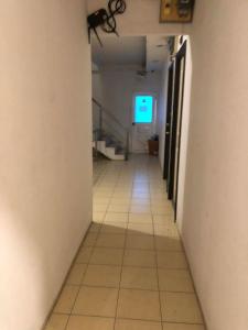 an empty hallway with a television in a building at จอมเทียน ซีไซด์ เกสเฮ้าส์ in Jomtien Beach +20 photos
