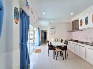 a kitchen and dining room with a table and chairs at Pool Marine Hua-Hin Private Poolvilla from beach 4 km in Hua Hin
