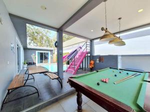 a pool table in a room with a swimming pool at Pool Marine Hua-Hin Private Poolvilla from beach 4 km in Hua Hin