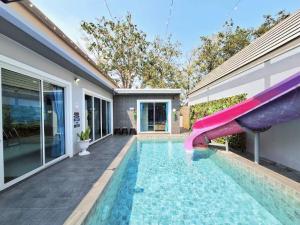 a swimming pool with a slide in a house at Pool Marine Hua-Hin Private Poolvilla from beach 4 km in Hua Hin