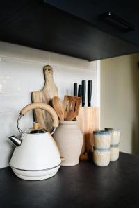 a kitchen counter with a tea kettle and other kitchen utensils at Naest - Authentic Escapes Old Town Villa Nijmegen in Nijmegen