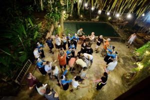 a group of people standing around a pool at Thái Tâm homestay in Mai Châu
