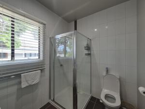 a bathroom with a shower and a toilet at Dempster House in Esperance +4 photos