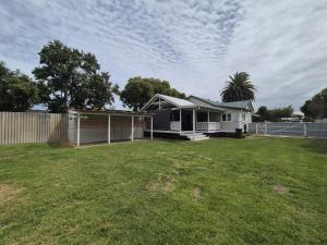 a small house in a yard with a fence at Dempster House in Esperance