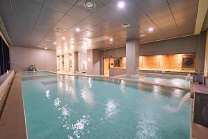 a large swimming pool in a hotel room at Chestertons Sokcho in Sokcho