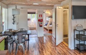 a kitchen and dining room with a table and chairs at 2 Bedroom Nice Home In Örkeljunga in Orkelljunga