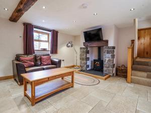 a living room with a couch and a fireplace at Briws in Llangwm