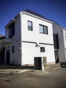 a white building with a garage in front of it at Tsukui 347 B in Yokosuka +39 photos