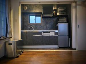 a kitchen with a sink and a refrigerator at Tsukui 347 B in Yokosuka