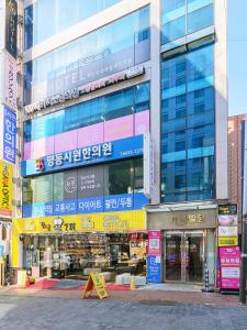 a large building with a lot of signs on it at K9 Myeongdong Hotel in Seoul