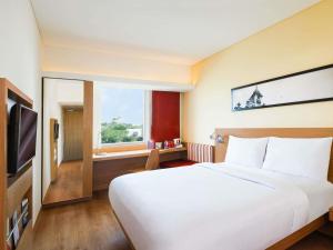 a bedroom with a large white bed and a window at ibis Gurgaon Golf Course Road - An Accor Brand in Gurgaon +82 photos