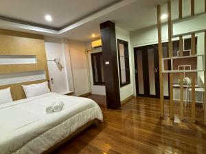 a bedroom with a bed with two towels on it at Anchan Home Stay Hatyai in Hat Yai