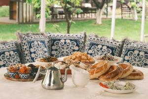 a table with bread and other food on it at Sunny Hostel in Osh