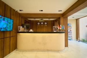 a lobby with a counter and clocks on the wall at Merak Pyramids Hotel in Cairo