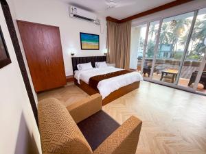 a hotel room with two beds and a balcony at Bella Vista Extended Stay in Kalyānpur +11 photos