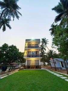 a tall building with a lawn in front of it at Bella Vista Extended Stay in Kalyānpur