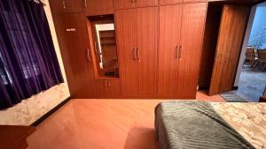 a bedroom with wooden cabinets and a bed in it at Zeno Villa Malpe By Beach County in Udupi
