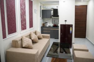a living room with a couch and a table at Rudra Homestay - Rishikesh in Rishīkesh