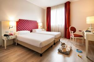 Кровать или кровати в номере Just Hotel Lomazzo Fiera