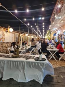 a group of people sitting at tables in a restaurant at Praça do Presidente in Santa Maria