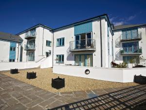 a row of white apartment buildings with a courtyard at Estuary View in Kingsbridge