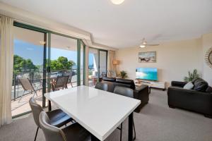 a living room with a white table and chairs at Seacrest Unit 2 Moffat Beach QLD in Caloundra