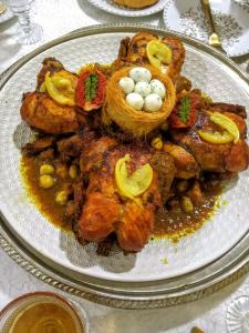 a plate of food with meat and eggs on it at Ferme agafay in El Karia +13 photos