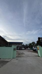 a parking lot with two refrigerators in front of a building at 5 Minutes Away Airport Lodge in Putatan