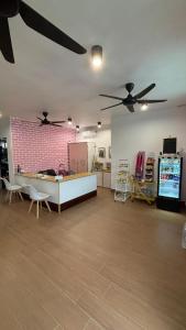 a living room with two ceiling fans and a table at 5 Minutes Away Airport Lodge in Putatan