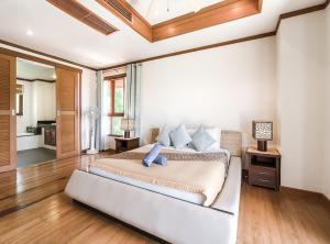 a bedroom with a large bed in a room at 4 Bedroom Sea View Villa TG48 on Beach Front Resort SDV288-By Samui Dream Villas in Thong Son Beach