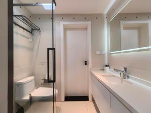 a bathroom with a toilet and a sink and a shower at Merit黄浦 Bright and Modern 2Bed Condo unit in downtown Shanghai in Shanghai