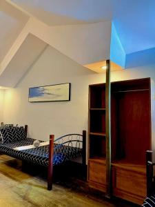 a bedroom with a bed and a book shelf at Chad's Lodge in Coron