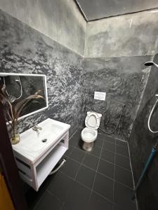 a bathroom with a sink and a toilet at Views Backpackers Hostel in Nongkhiaw