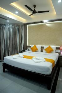 a bedroom with a large bed with yellow pillows at KRISHNA HOLIDAY VILLAGE in Trichūr +31 photos