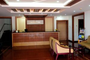 a hotel lobby with a reception desk and chairs at KRISHNA HOLIDAY VILLAGE in Trichūr