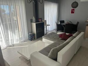 a living room with a white couch and a table at Bright house in Bar