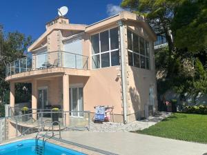 a house with a pool in front of it at Bright house in Bar