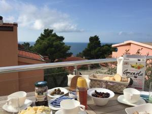 a table with food on top of a balcony at Bright house in Bar